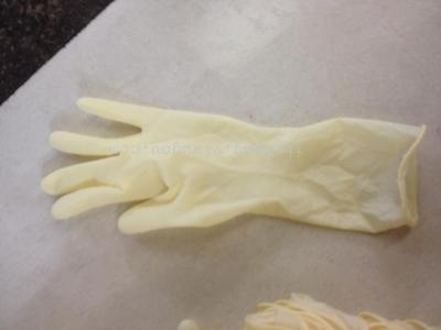 Disposable 12 inch latex gloves yellow left hand.