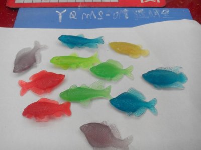 Small toys and a variety of fish in bulk woven bags