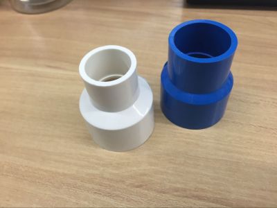 Reducing directly. White and blue, PVC pipe fittings series......