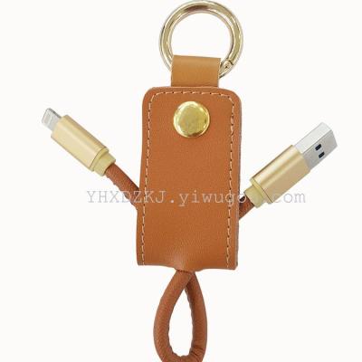 The new creative gift leather portable key button data wire button charging cable with a handbag mobile power supply