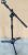 Microphone holder console with floor type metal tripod.