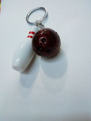 Plastic bowling pin with bottle key.