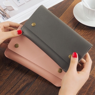 In 2017, the new long style purse, pure color magnetic button female purse card bag