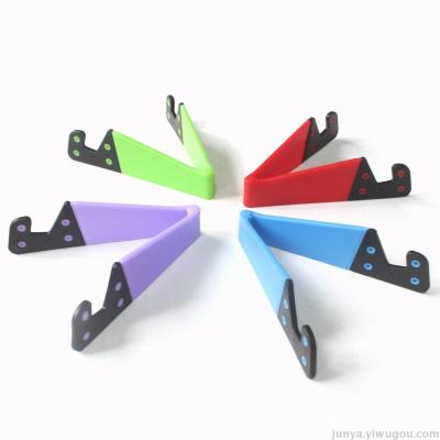 Creative V-shaped bracket color desktop phone lazy stent universal folding V-type mobile phone bracket wholesale