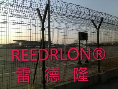 The REEDRLON fence is a green, barbed wire, airport fence