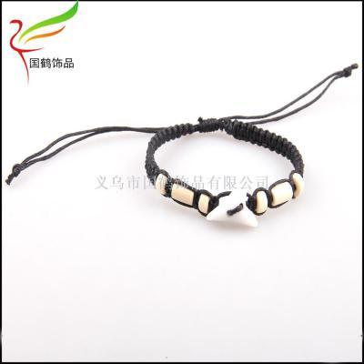 Shark-toothed wooden beads are woven into individual bracelets.