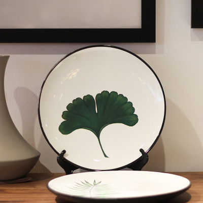 Modern simple ceramic plate hanging plate decorated with ginkgo leaf.