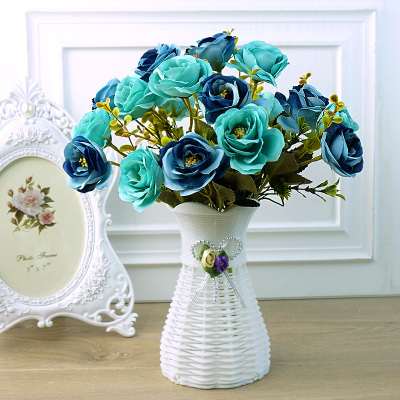 The living room bedroom is decorated with plastic fake flowers to simulate dry bouquet decoration small potted 
