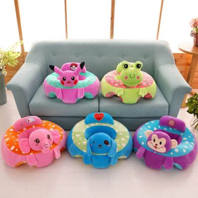 The baby learns to sit in the chair infant safety seat small sofa plush toy.