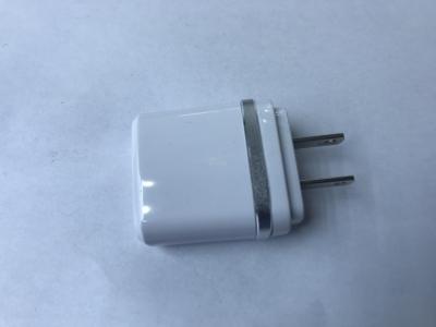 Two USB cell phone chargers with two USB plugs.