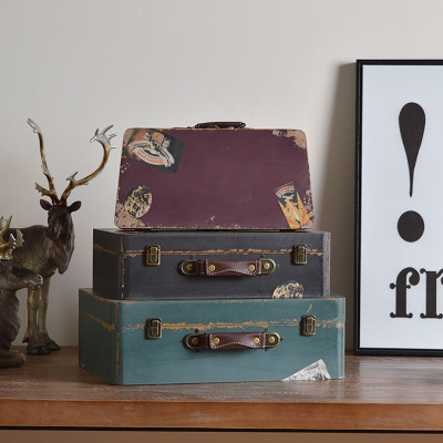 A set of three decorative suitcases for photography props.