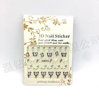 Fingernails decorated with 3D fingernails and black and white nail paste.