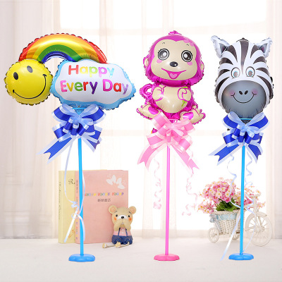 Children's first birthday party balloons decorated table with a mini balloon stand on the base cartoon table decoration.