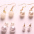 Polychromatic double pearl earrings with a variety of earrings with a variety of earrings.