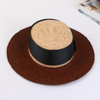 A straw hat with a large brim, and a hat for a summer hat.