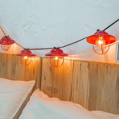 The romantic room of the bedroom is decorated with small light bulbs
