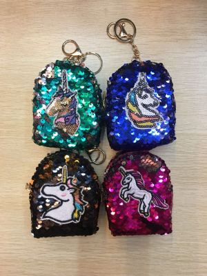 A small backpack with a sequinned purse and a unicorn patch