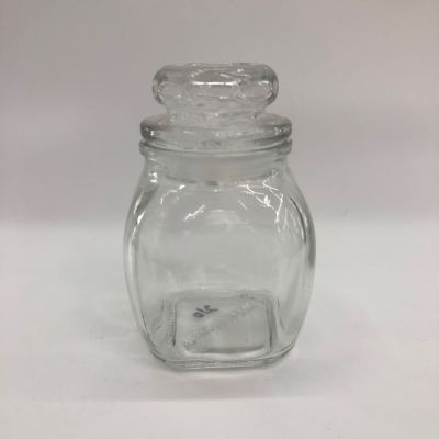 A small square bottle with A small glass lid