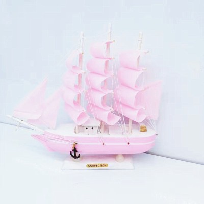 The girl is Mediterranean style pink model sailboat decoration wooden boat plain decoration