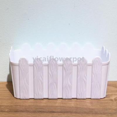 Plastic flowerpot with rectangular wooden fence basin
