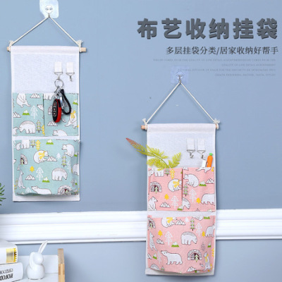 The manufacturer directly provided cotton and linen three-pocket; their cle hanging bag for hanging hanging bag in The bathroom after The door