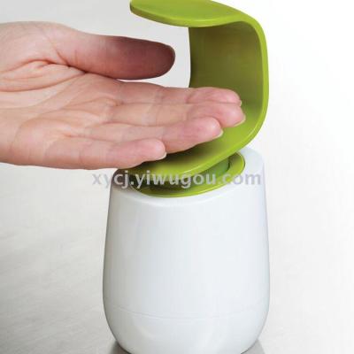 Pressure the back of your hand on a bottle of hand sanitizer