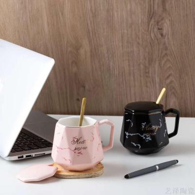 Marbled coffee cup with a spoon and a top grade coffee cup.