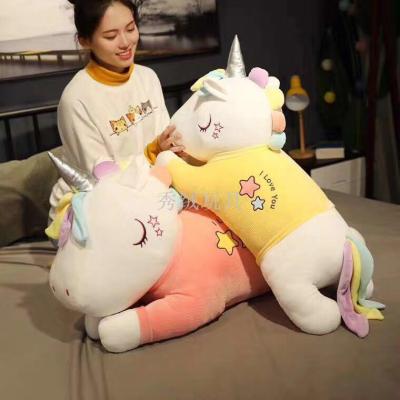A stuffed unicorn doll A girl sleeps in bed with A pillow and A large doll gives her girlfriend A gift