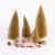 Christmas table tops are decorated with golden pine needles and mini Christmas trees dusted with powder