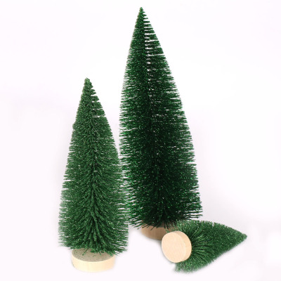 Christmas table tops are decorated with green pine needles and mini Christmas trees dusted with powder