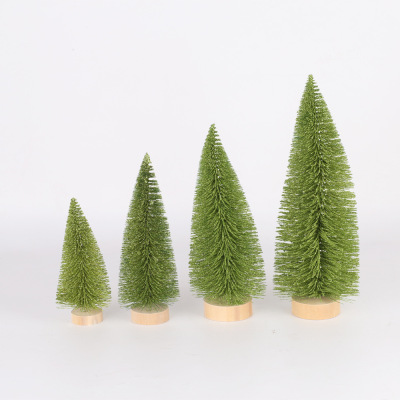 Christmas table tops are decorated with light green pine needles and mini Christmas trees dusted with powder