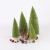 Christmas table tops are decorated with light green pine needles and mini Christmas trees dusted with powder