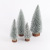 Christmas table tops are decorated with colorful pine needles and powdered mini Christmas trees