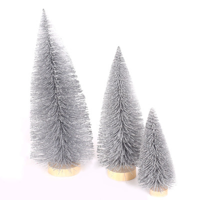 Christmas table tops are decorated with grey pine needles and mini Christmas trees dusted with powder