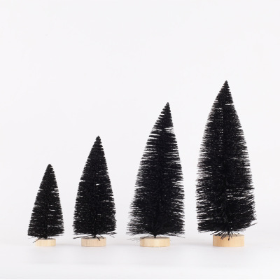 Christmas table tops are decorated with black pine needles and mini Christmas trees dusted with powder