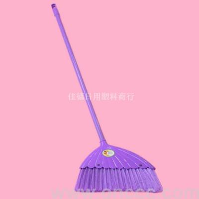 The purple broom sweeps the plastic pp.