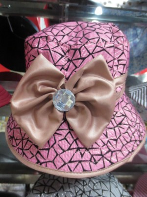 Ribbon bows adorn this round hats