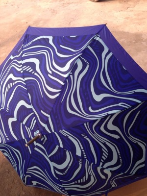 An advertising umbrella with a purple top hook