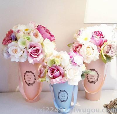 Round white flower bucket with flower bucket in hand holds flower sweet box flowers bouquet bucket in hand