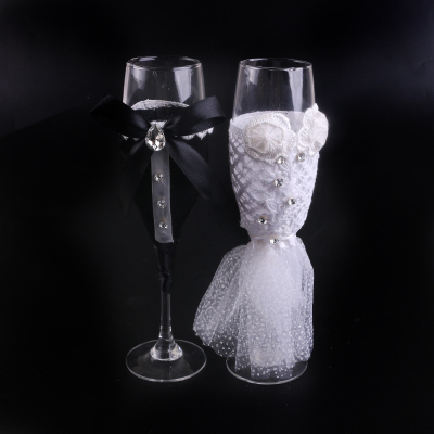 Bride and groom wedding dress cocktail dress goblet champagne glasses black and white dress.