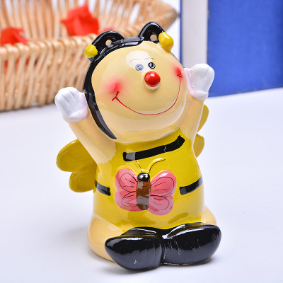 Cartoon color ceramic honeybee small bee piggy bank children cute change can table top with a piggy bank.