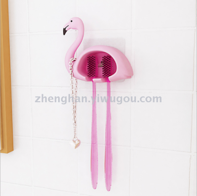 The flamingo toothbrush hangs from the toilet