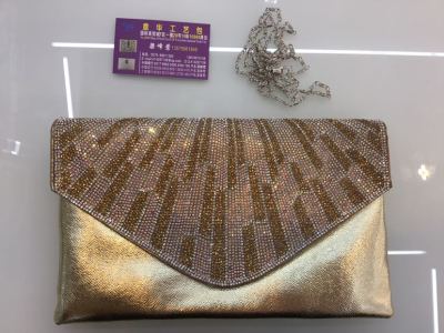 The diamond evening bag is slung over The lady's fashion bag