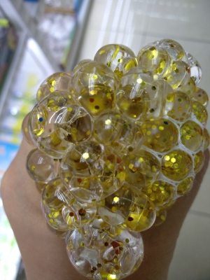 Manufacturers direct cylinder pressure ball golden powder children adult grapes release ball pinched music toys