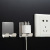 The stainless steel power plug-in  non - nail - paste type socket receptacle mobile phone charging wall mounting bracket