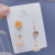 Japanese and Korean creative move asymmetrical tik sound with a small yellow duck earrings lovely heart tassel ear hook