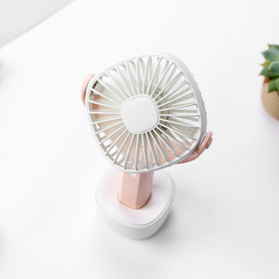 The new rotate hand-held fan with a small outdoor mini USB charging base LED night light fan