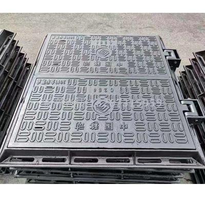 Cast iron manhole cover with sphenoidal ink grate and resin manhole cover