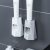 Automatic toothpaste extruder set with wall-hanging non-perforating toothpaste and toothbrush shelving toothpaste rack