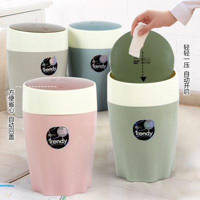 Plastic press kitchen USES a large circular trash bin with lid to store bin paper baskets in the bathroom